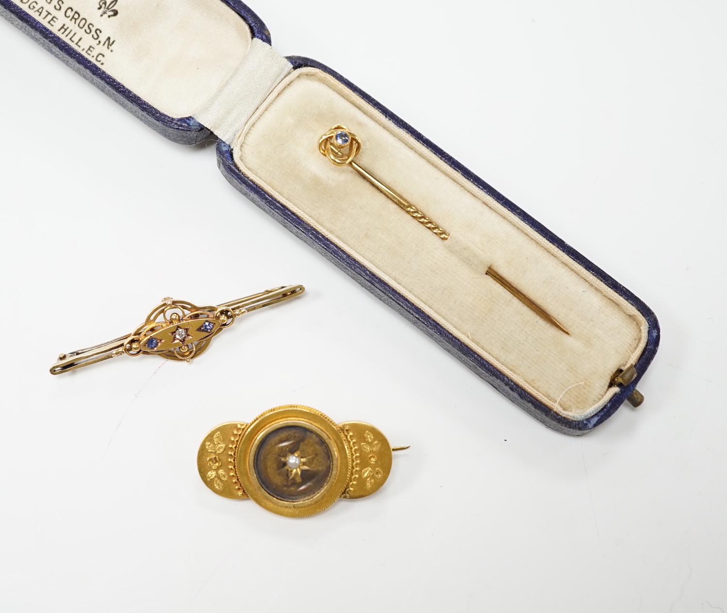 An Edwardian 15ct, sapphire and diamond set three stone bar brooch, 48mm, a later 14ct gold enamel and baroque pearls set 'Kingfisher' bar brooch, one other yellow metal and seed pearl set brooch and an Edwardian 15ct an